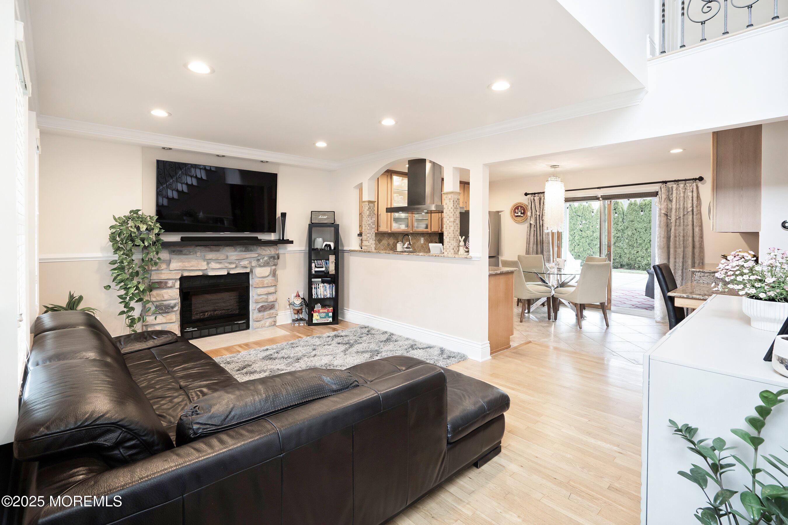 21 Drexel Drive Jackson, NJ 08527 - Photo 6 of 36 a living room with furniture a flat screen tv and a fireplace