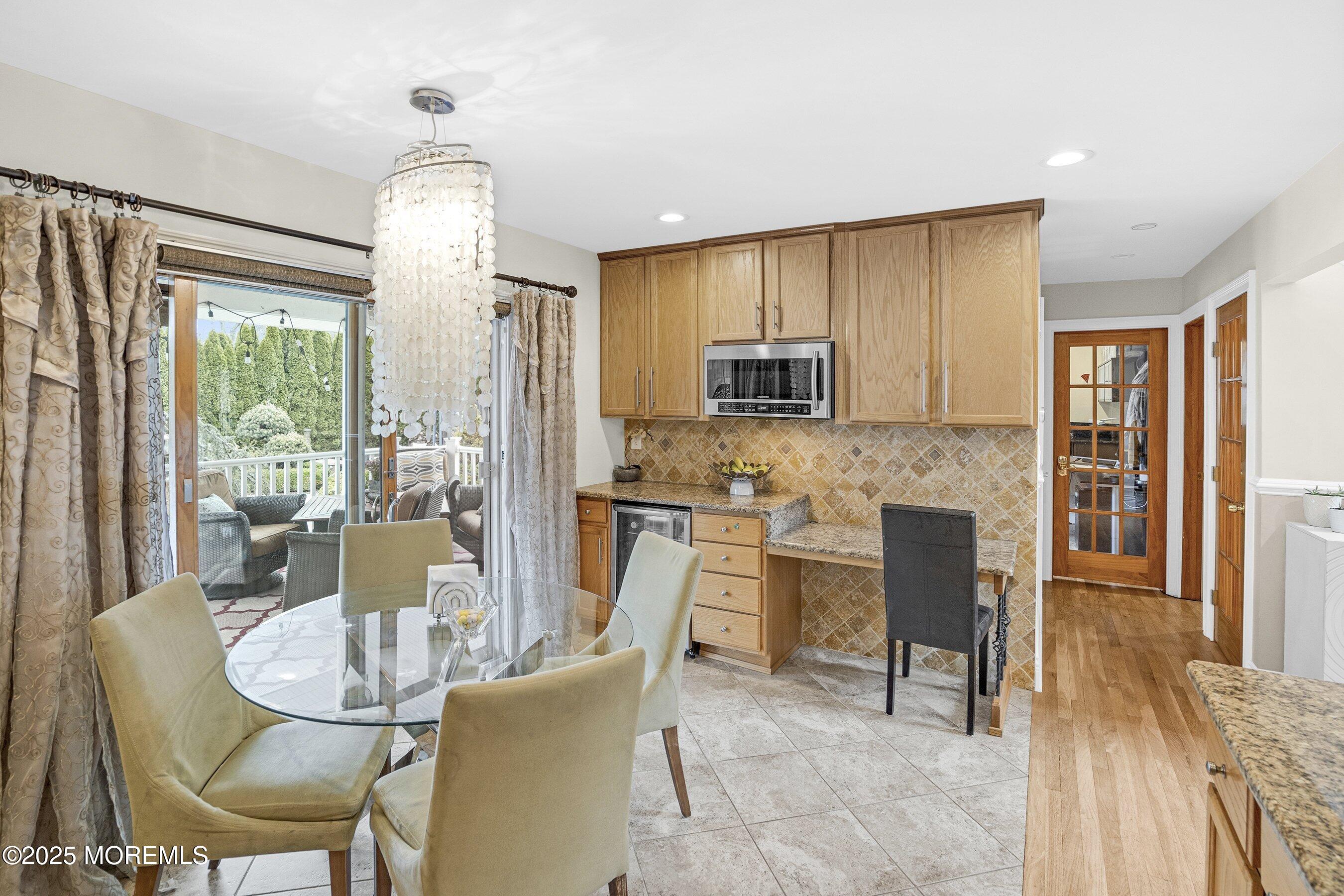 21 Drexel Drive Jackson, NJ 08527 - Photo 8 of 36 a dining room with furniture a window and a kitchen view