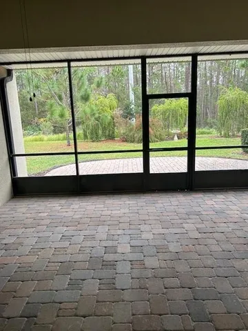 a view of empty room with large windows