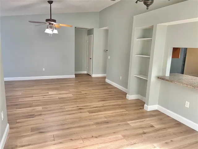 a view of a room with wooden floor and cabinet