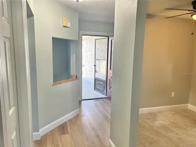 a view of a hallway with wooden floor