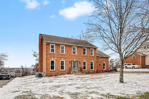 a front view of a building with a yard