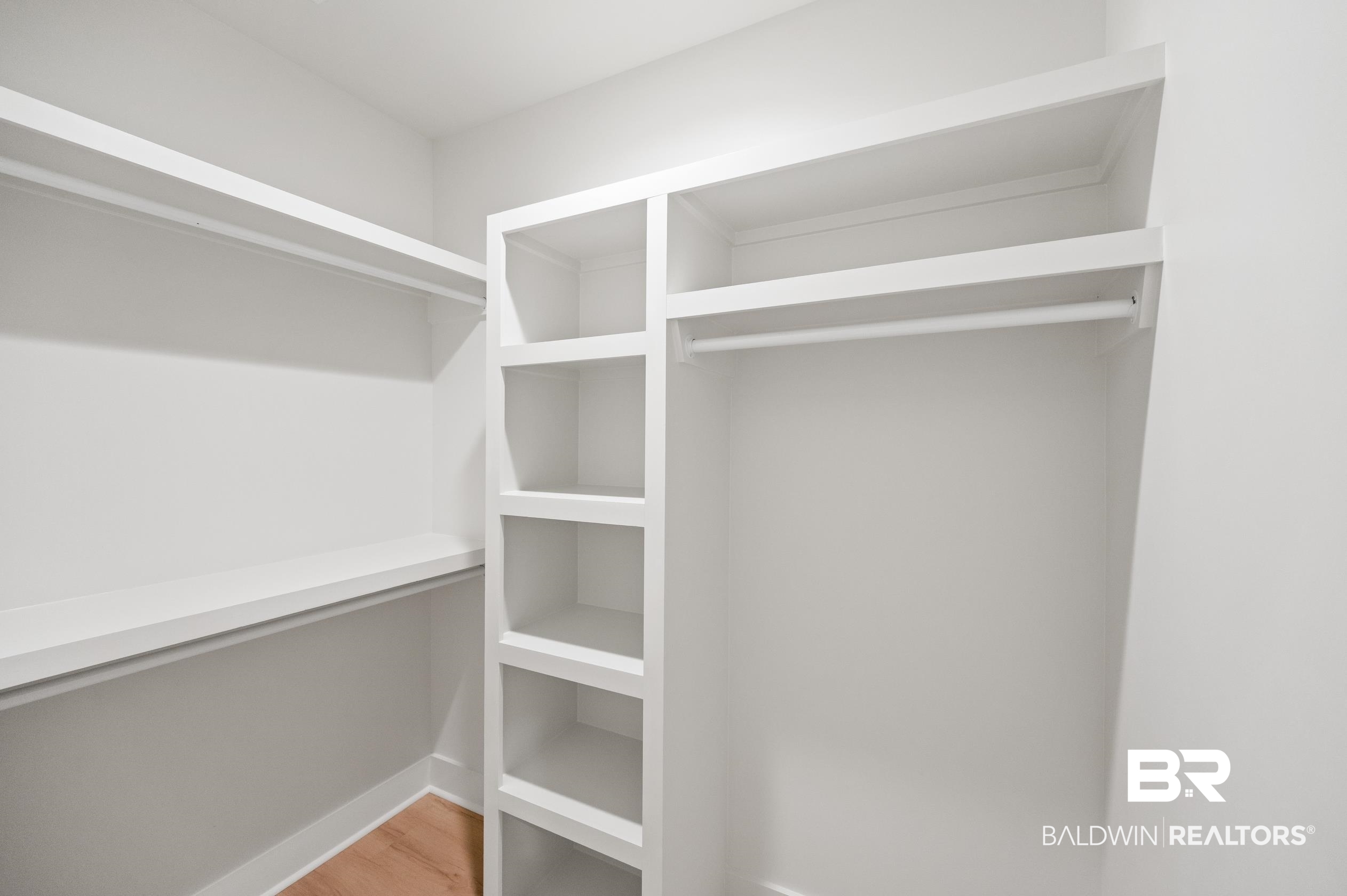 28889 Canal Road Orange Beach, AL 36561 - Photo 37 of 55 Walk in closet with hardwood / wood-style flooring