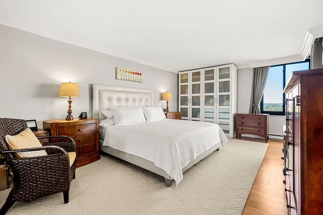 a bedroom with bed window and couch