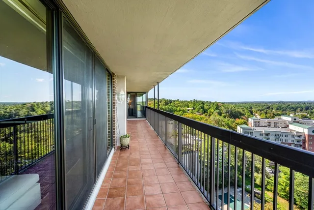 a view of a patio with table and chairs potted plants and large tree