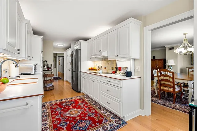 a kitchen with stainless steel appliances granite countertop a refrigerator sink and cabinets