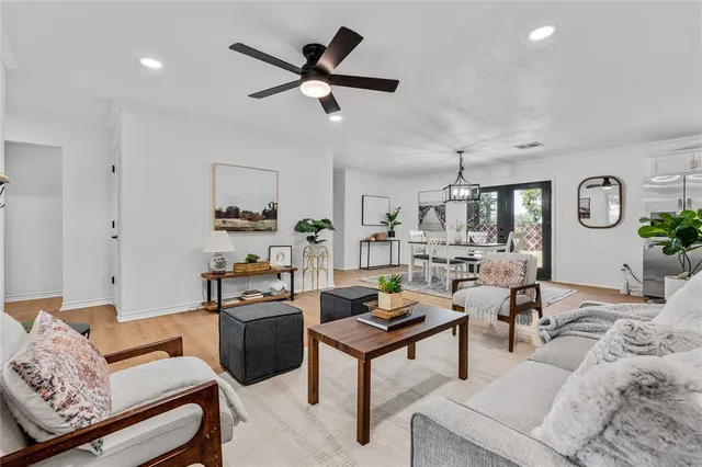 a living room with furniture and kitchen view