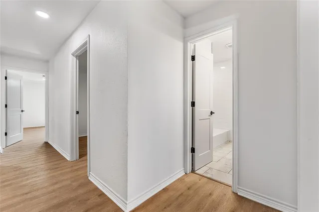 a view of hallway with wooden floor
