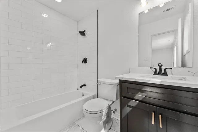 a bathroom with a sink toilet a mirror and shower