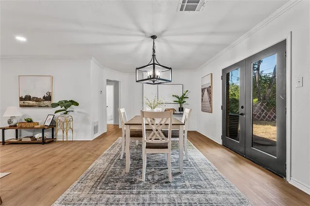 a dining room with furniture window and wooden floor