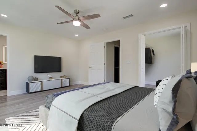 a bedroom with a bed and a flat screen tv