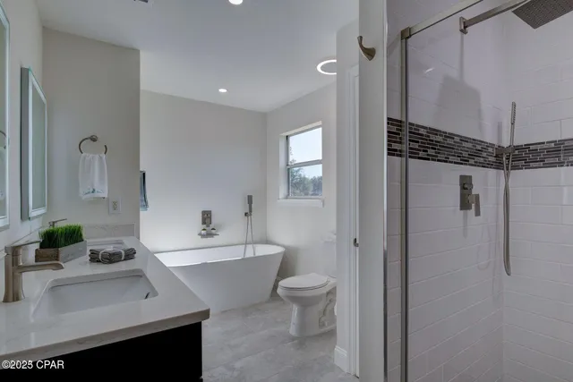 a bathroom with a bathtub shower sink and toilet