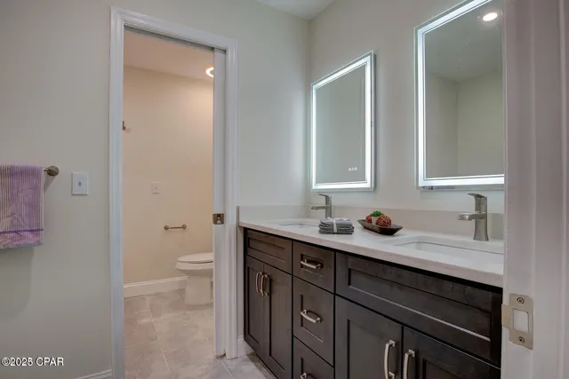 a bathroom with a toilet sink and mirror