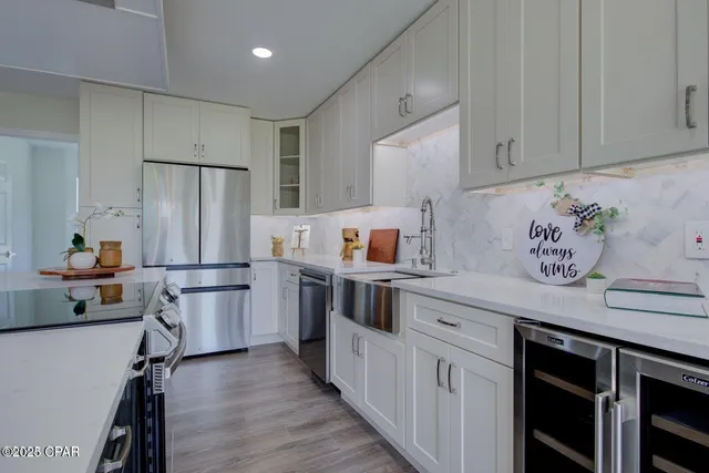 a kitchen with stainless steel appliances a stove a sink and a refrigerator