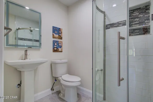 a bathroom with a sink toilet and shower