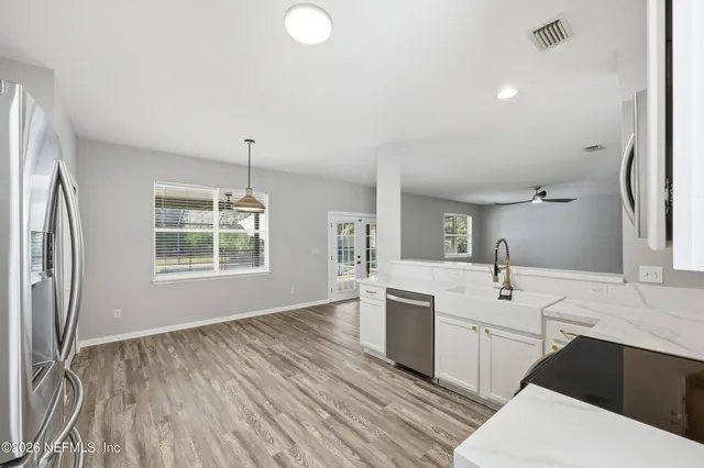 a spacious bathroom with a double vanity sink a mirror and a bathtub