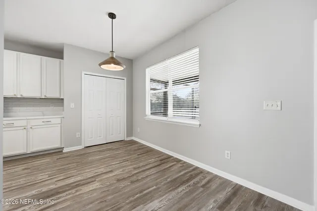 a view of a kitchen with a dishwasher cabinets and wooden floor