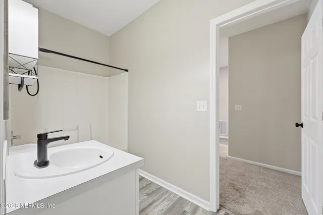 a bathroom with a sink and mirror