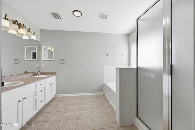 a bathroom with a double vanity sink and mirror