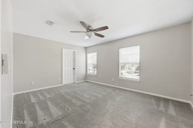 a view of an empty room with a window