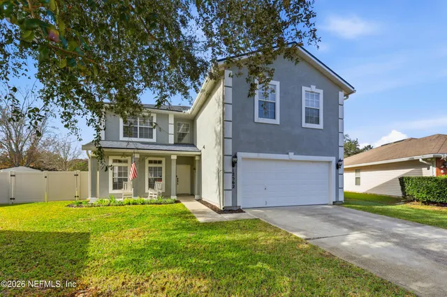 a front view of house with yard and green space