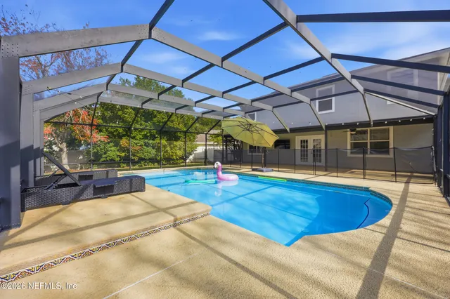 a view of a backyard with swimming pool
