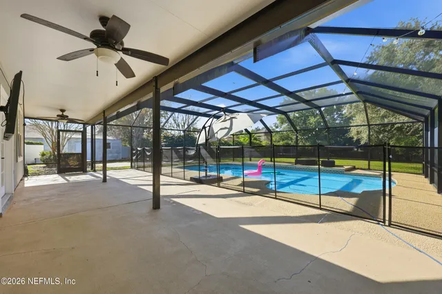 a view of a swimming pool and trees in the background