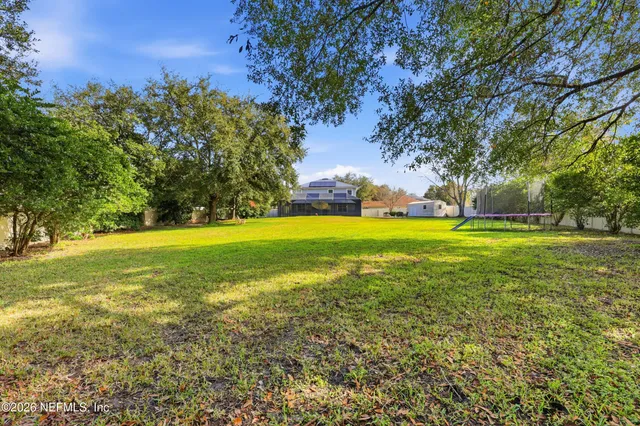 a front view of house with yard and trees