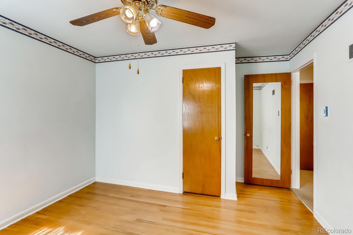 440 South Raleigh Street Denver, CO 80219 - Photo 13 of 29 a view of empty room with wooden floor
