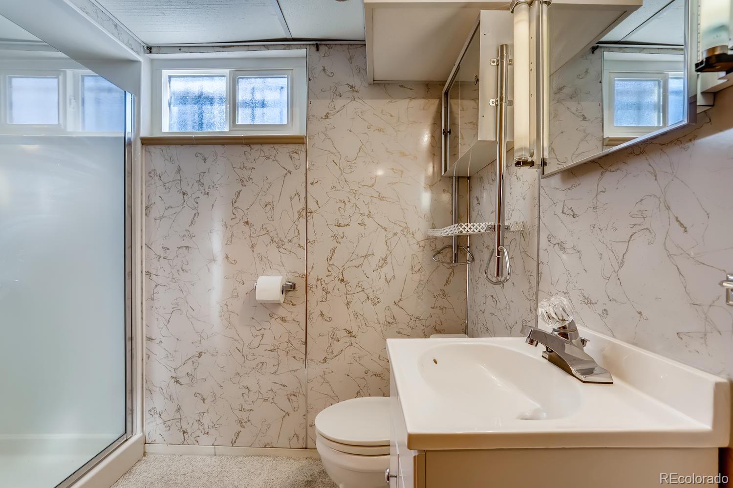 440 South Raleigh Street Denver, CO 80219 - Photo 19 of 29 a bathroom with a sink a toilet and shower