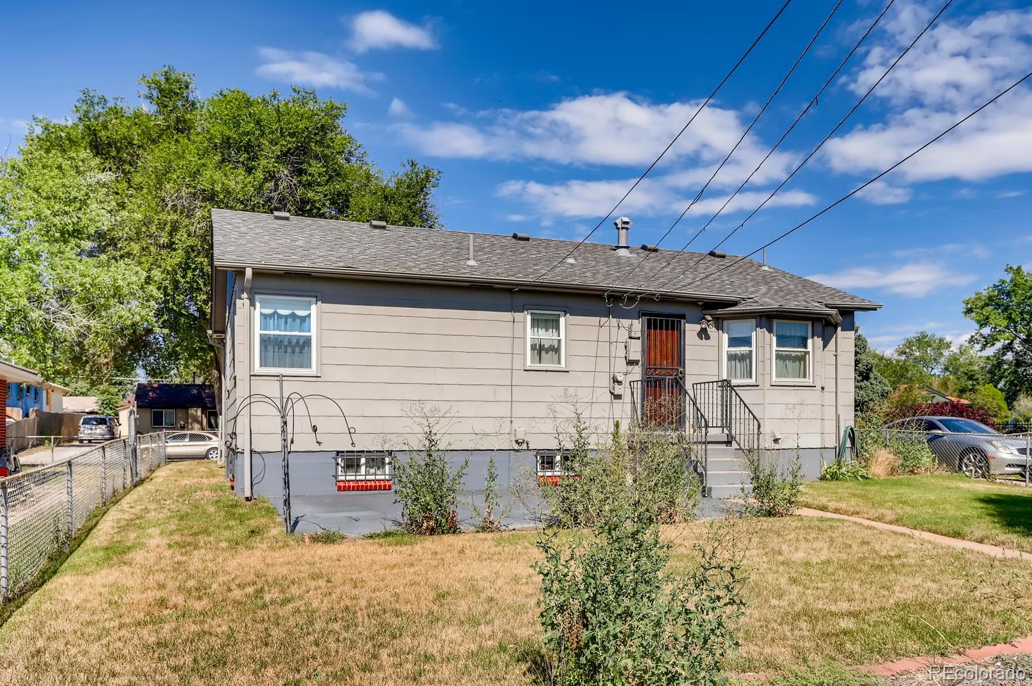 440 South Raleigh Street Denver, CO 80219 - Photo 21 of 29 a view of a house with a small yard and a large tree