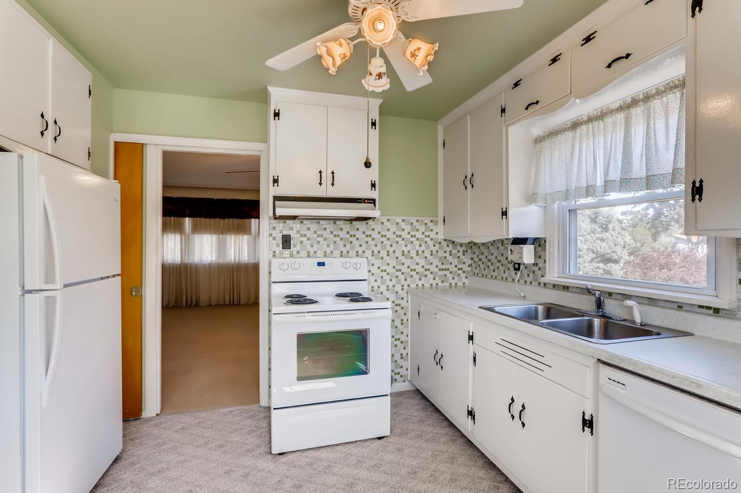440 South Raleigh Street Denver, CO 80219 - Photo 8 of 29 a kitchen with white cabinets and white appliances