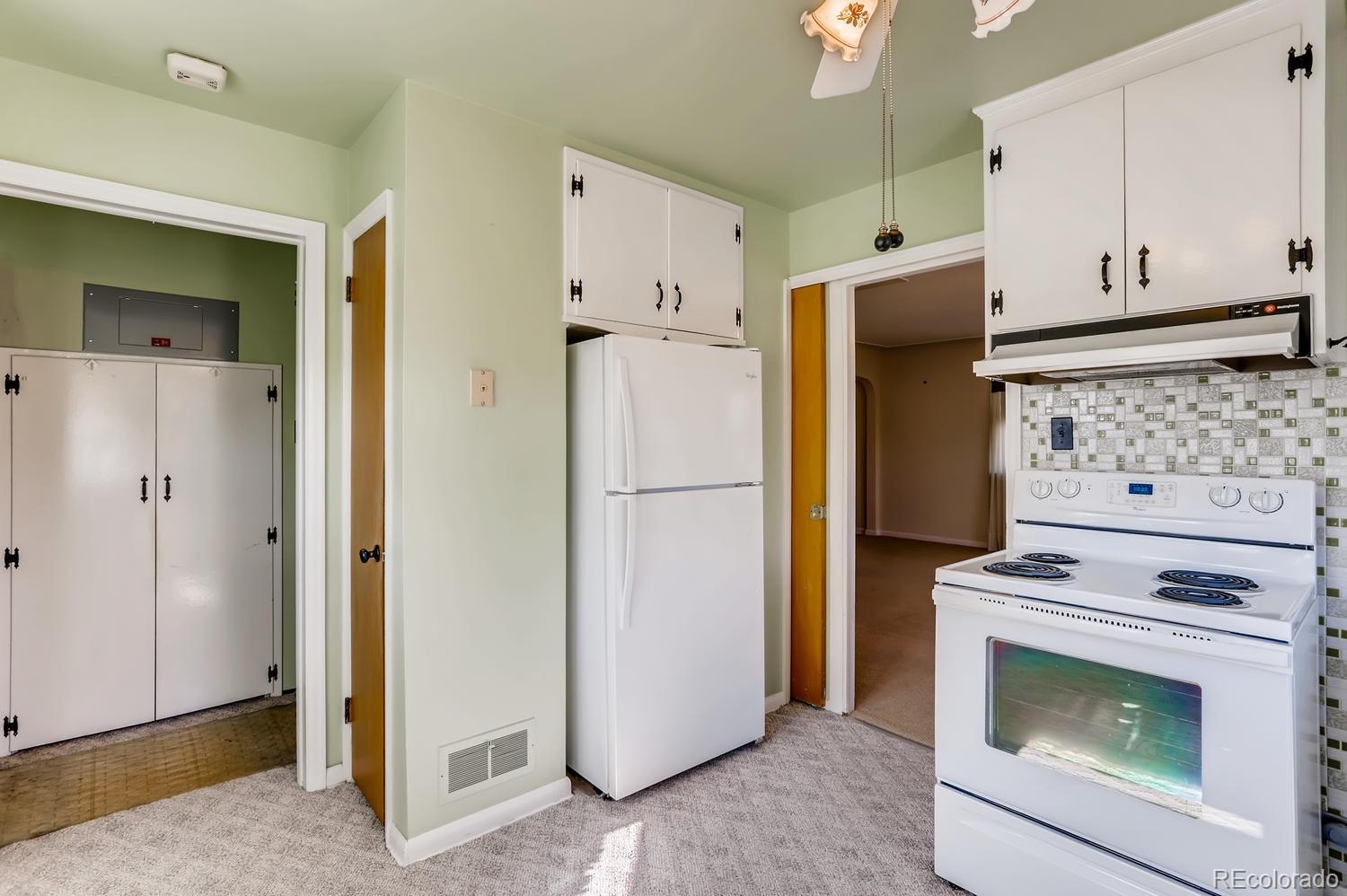 440 South Raleigh Street Denver, CO 80219 - Photo 9 of 29 a kitchen with a refrigerator and stove