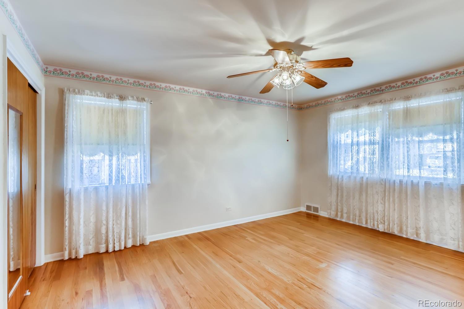 440 South Raleigh Street Denver, CO 80219 - Photo 10 of 29 wooden floor in an empty room with a window