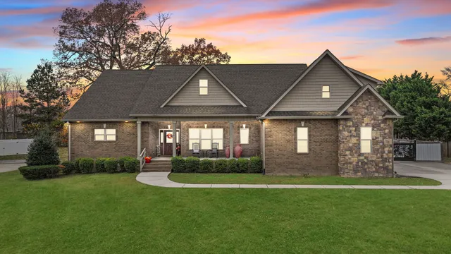 a front view of a house with a yard and outdoor seating