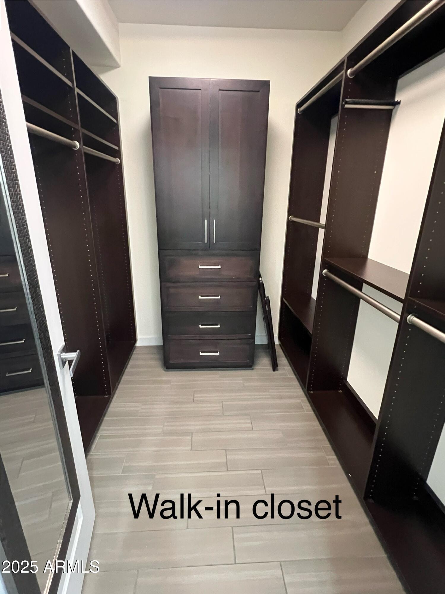 4803 North Woodmere Fairway, Unit 1004 Scottsdale, AZ 85251 - Photo 15 of 21 a view of walk in closet with wooden floor