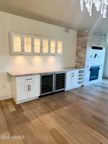 a view of an empty room with a fireplace and a window