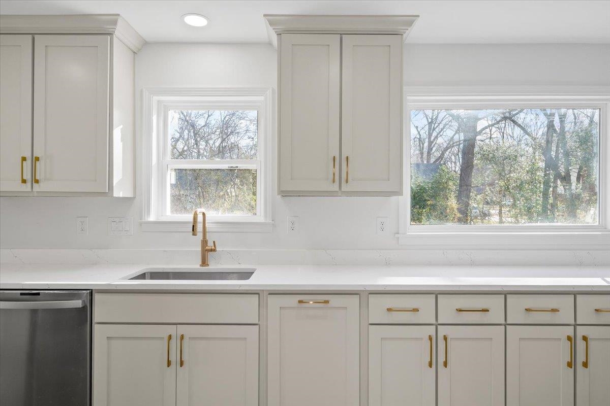1676 Miller Farms Road Germantown, TN 38138 - Photo 13 of 37 Kitchen featuring light-toned cabinetry with gold-toned hardware, white countertops, and a gold-toned gooseneck faucet
