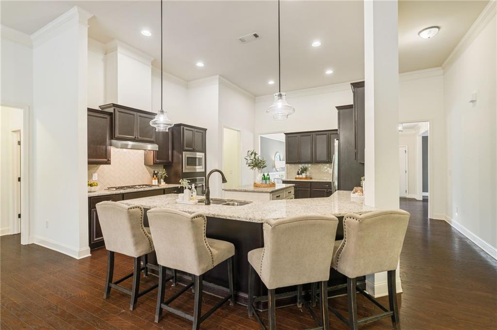 4735 Amble Trace Cumming, GA 30040 - Photo 6 of 73 a large kitchen with a table and chairs
