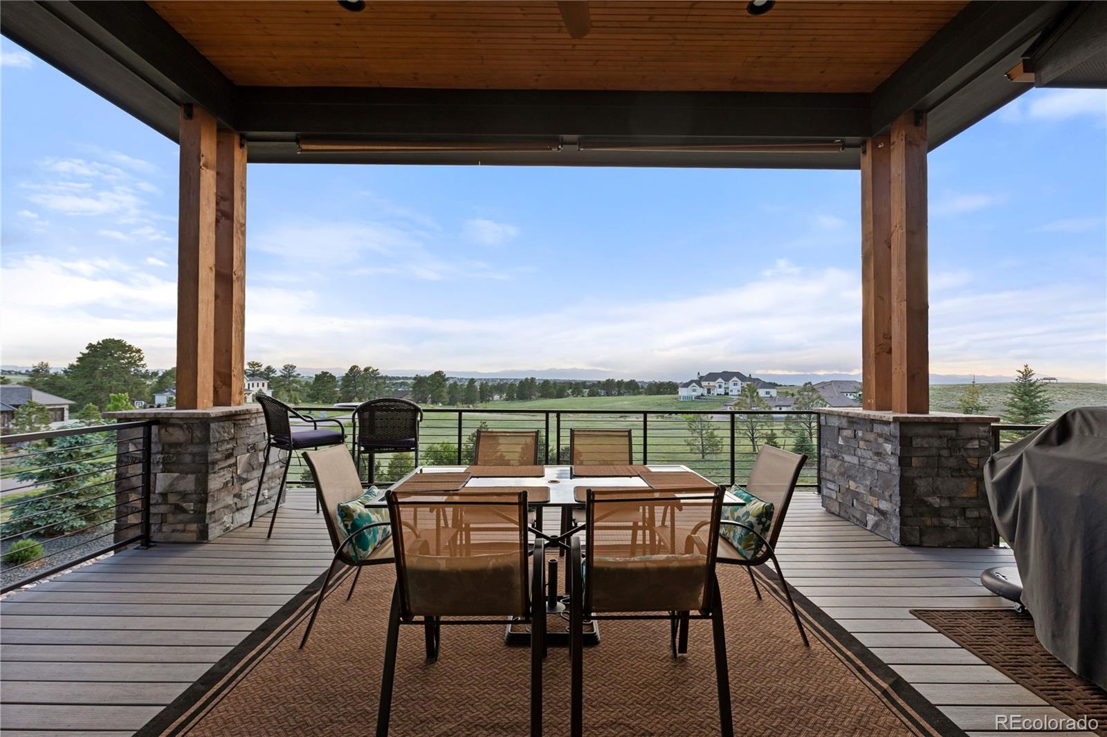 10689 Shadow Pines Road Parker, CO 80138 - Photo 35 of 50 a view of a balcony with table and chairs