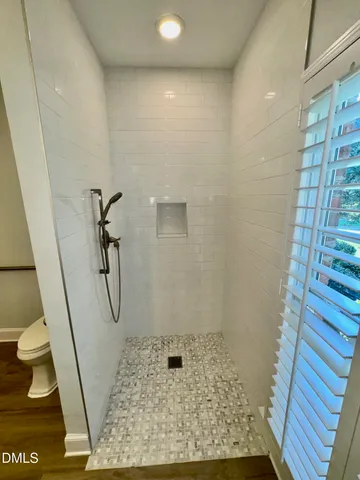 an empty room with windows and ceiling fan