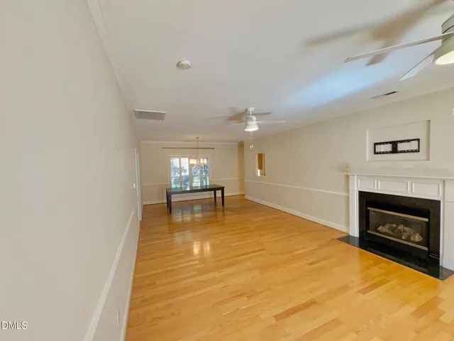a view of an empty room with a fireplace