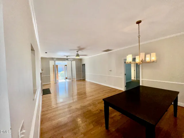 a view of a livingroom with a furniture wooden floor and staircase
