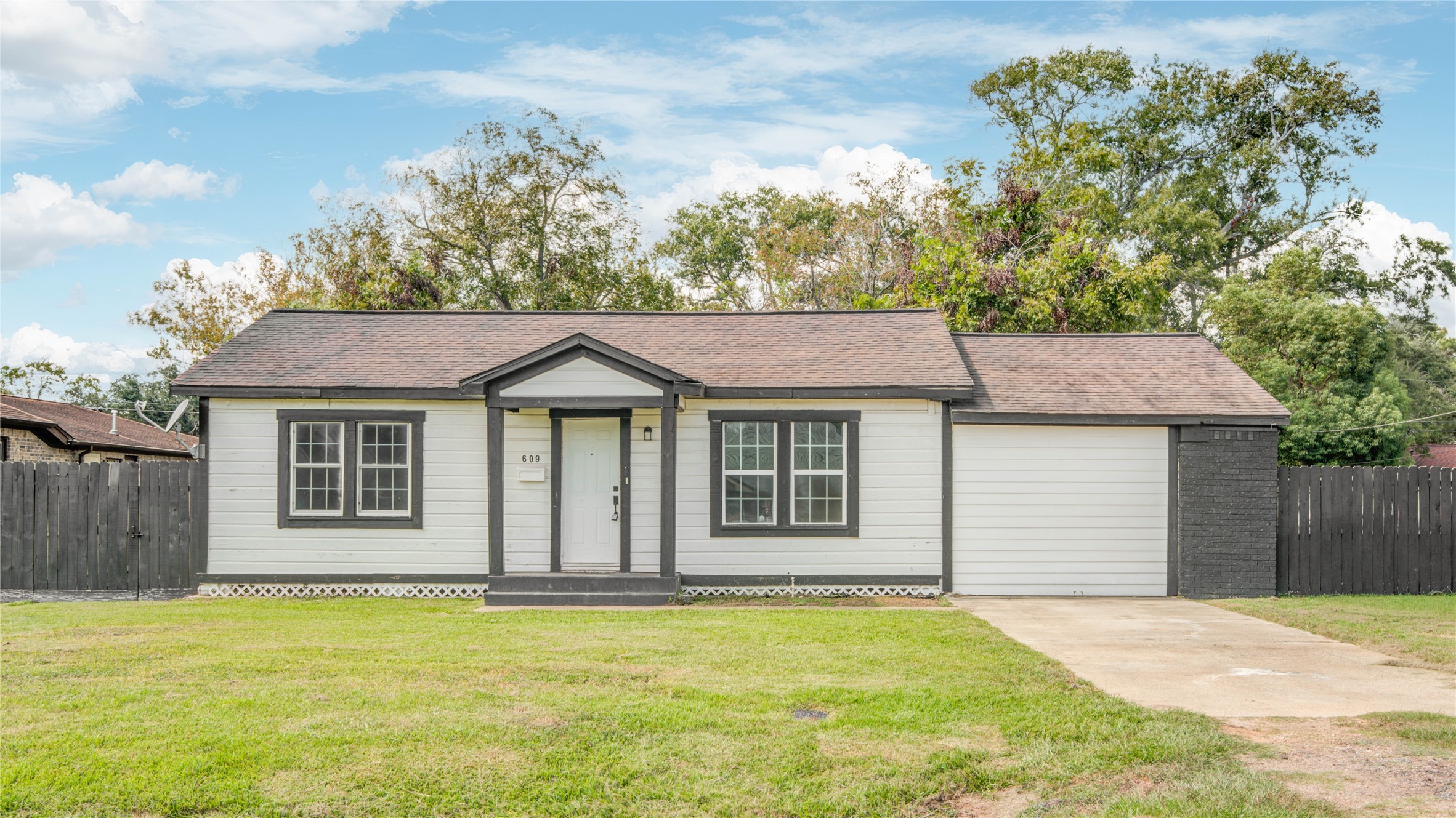 609 Hurst Place Angleton, TX 77515 - Photo 2 of 36 a front view of a house with a garden