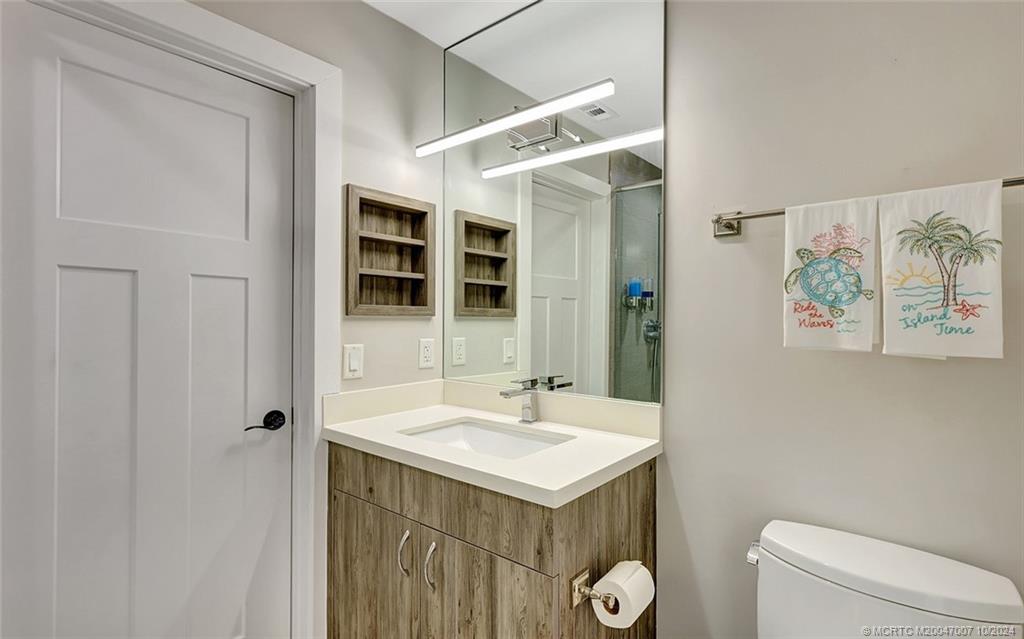 26 Rio Vista Drive Stuart, FL 34996 - Photo 27 of 58 a bathroom with a sink toilet and shower