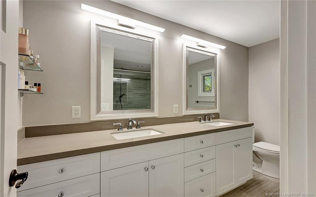 26 Rio Vista Drive Stuart, FL 34996 - Photo 44 of 58 a bathroom with a double vanity sink and a mirror