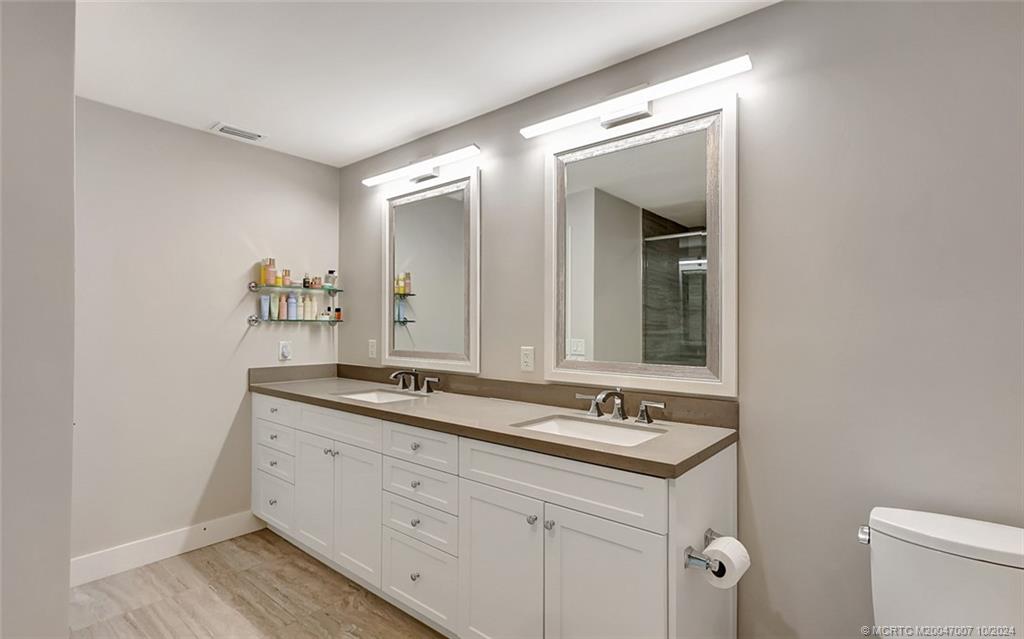 26 Rio Vista Drive Stuart, FL 34996 - Photo 46 of 58 a bathroom with a sink and a mirror