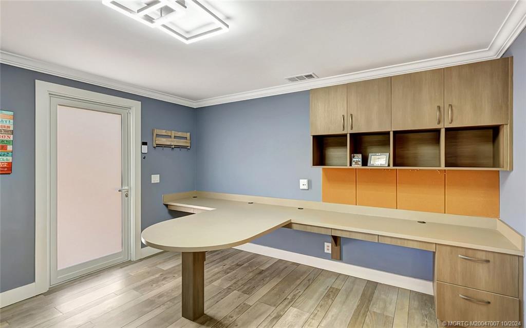 26 Rio Vista Drive Stuart, FL 34996 - Photo 49 of 58 a room with a wooden floor and furniture