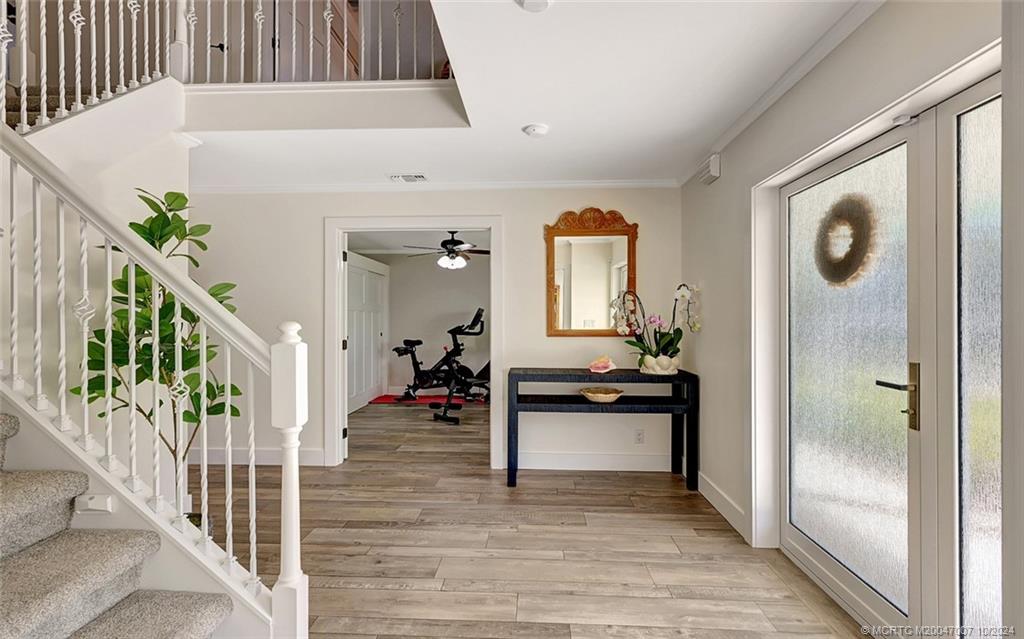 26 Rio Vista Drive Stuart, FL 34996 - Photo 9 of 58 a view of a hallway to a livingroom with wooden floor and furniture