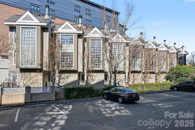 a car parked in front of a white house